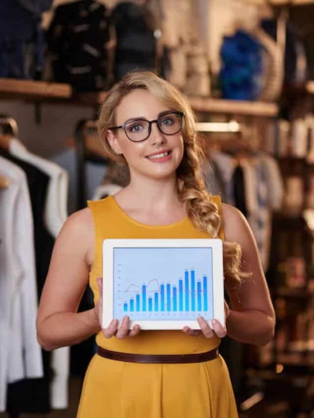beautiful-caucasian-lady-posing-boutique-showing-tablet-with-sales-graph_1098-20658